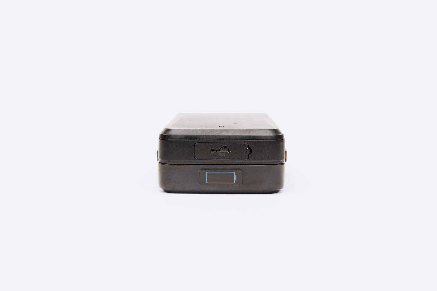 A close-up view of the Protect Plus Strong Magnet GPS Tracker showing its USB charging port, power button, and a visual battery level indicator on a small display.