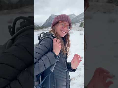A person in a wintery, mountainous setting holds the Mobile-200 GPS tracker in a video that likely discusses its safety applications for individuals who enjoy camping and traveling in remote areas.